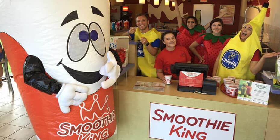 A group of Smoothie King franchisees posing in front of a mascot.