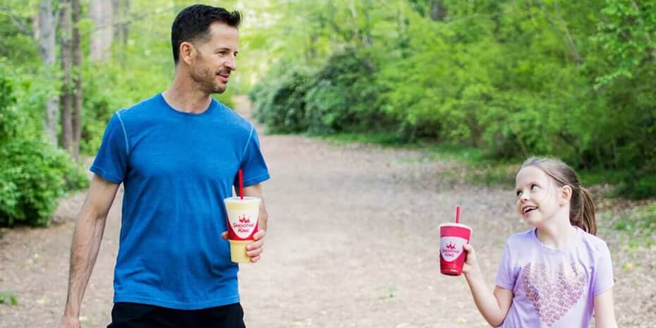 A man and a little girl walking down a cleaner path.