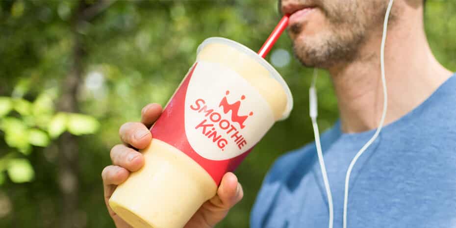 A man savoring a smoothie from a cup during the alternative protein craze.