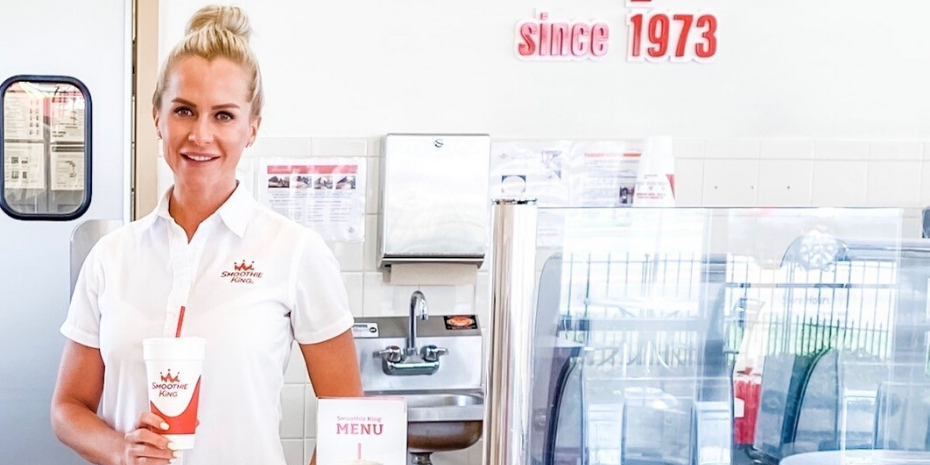 A woman standing in front of an ice cream shop on her journey as a multi-unit franchisee.