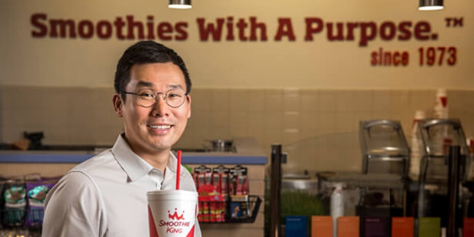 A man standing in front of smoothies pondering The Most Important Question Every Business Owner Must Answer.