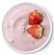 A bowl of strawberry yogurt with two strawberries in it, perfect for a smoothie shop menu.