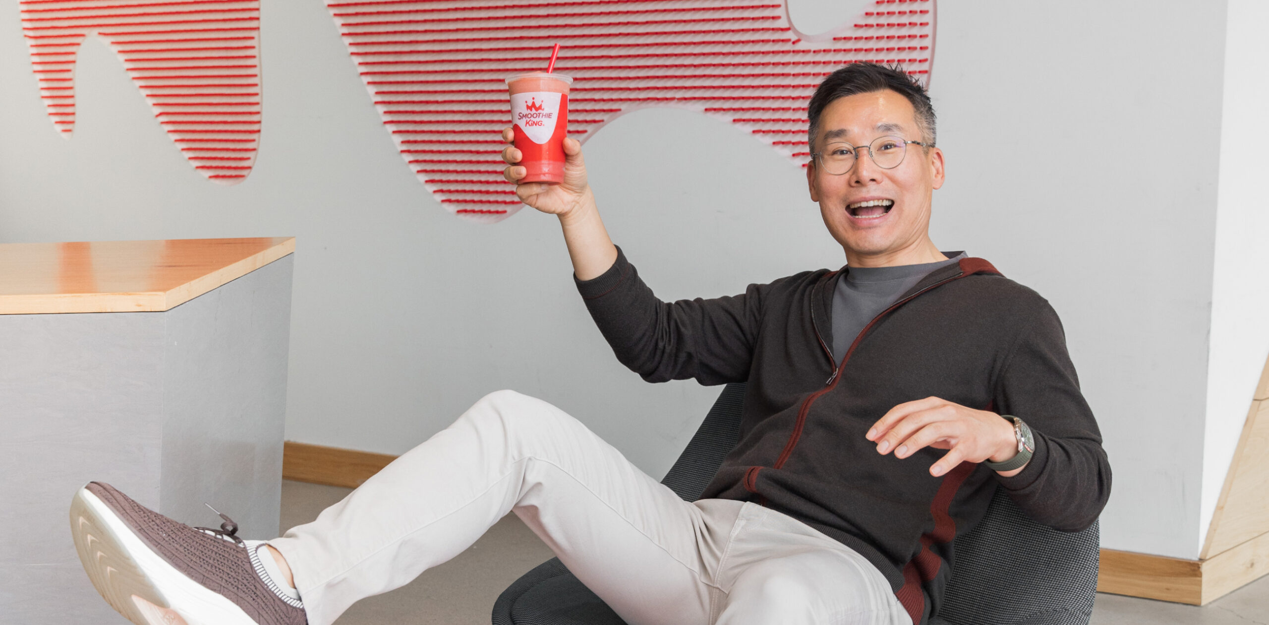 Wan Kim Playfully falling with a Smoothie King cup